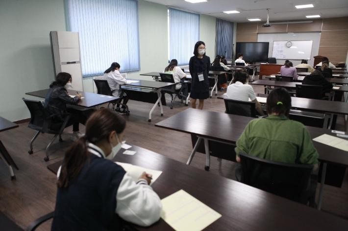 A classroom setting with students taking a test.