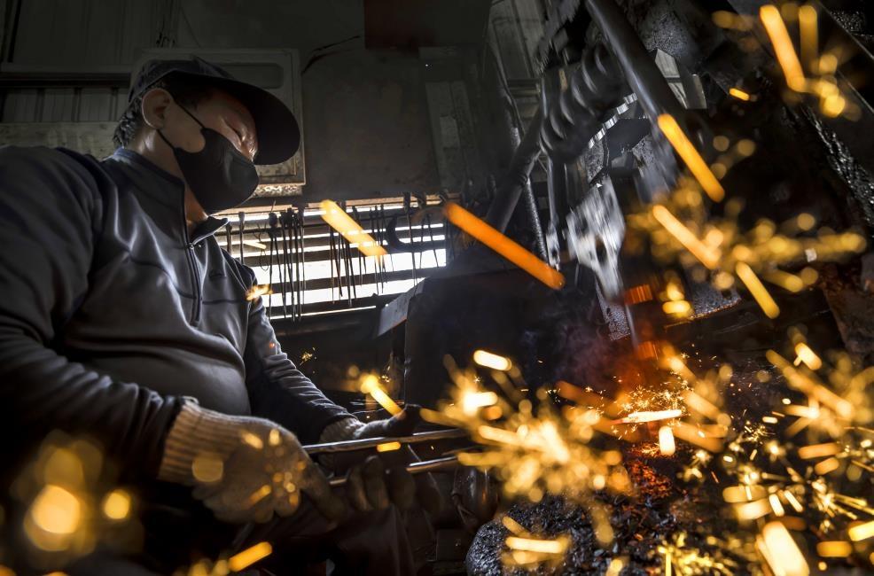 Metal tool blanks heating inside a glowing coal forge