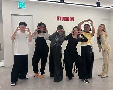 Class participants posing for photos in a Seoul dance studio after filming their K-Pop choreography