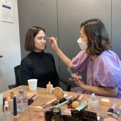 Professional makeup artist applying eye makeup during a Seoul makeup session