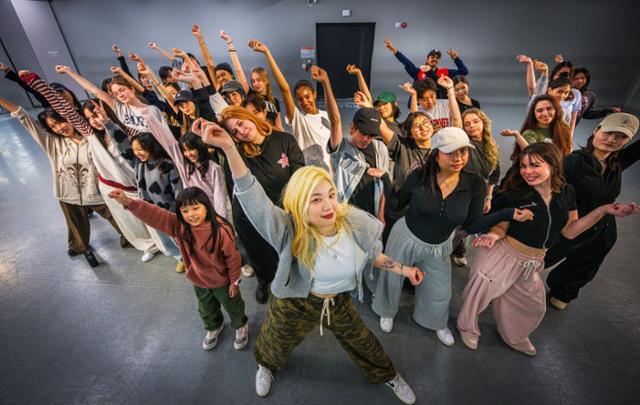 International participants dancing together during a hands-on K-Pop dance class in a Seoul studio