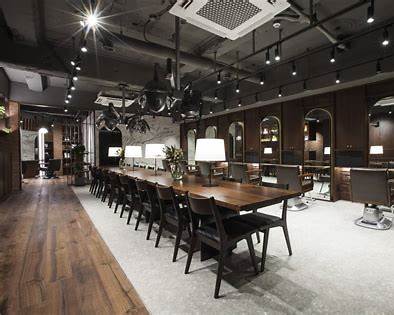 Design-led Seoul hair salon with a long communal wooden table and dark wood styling stations