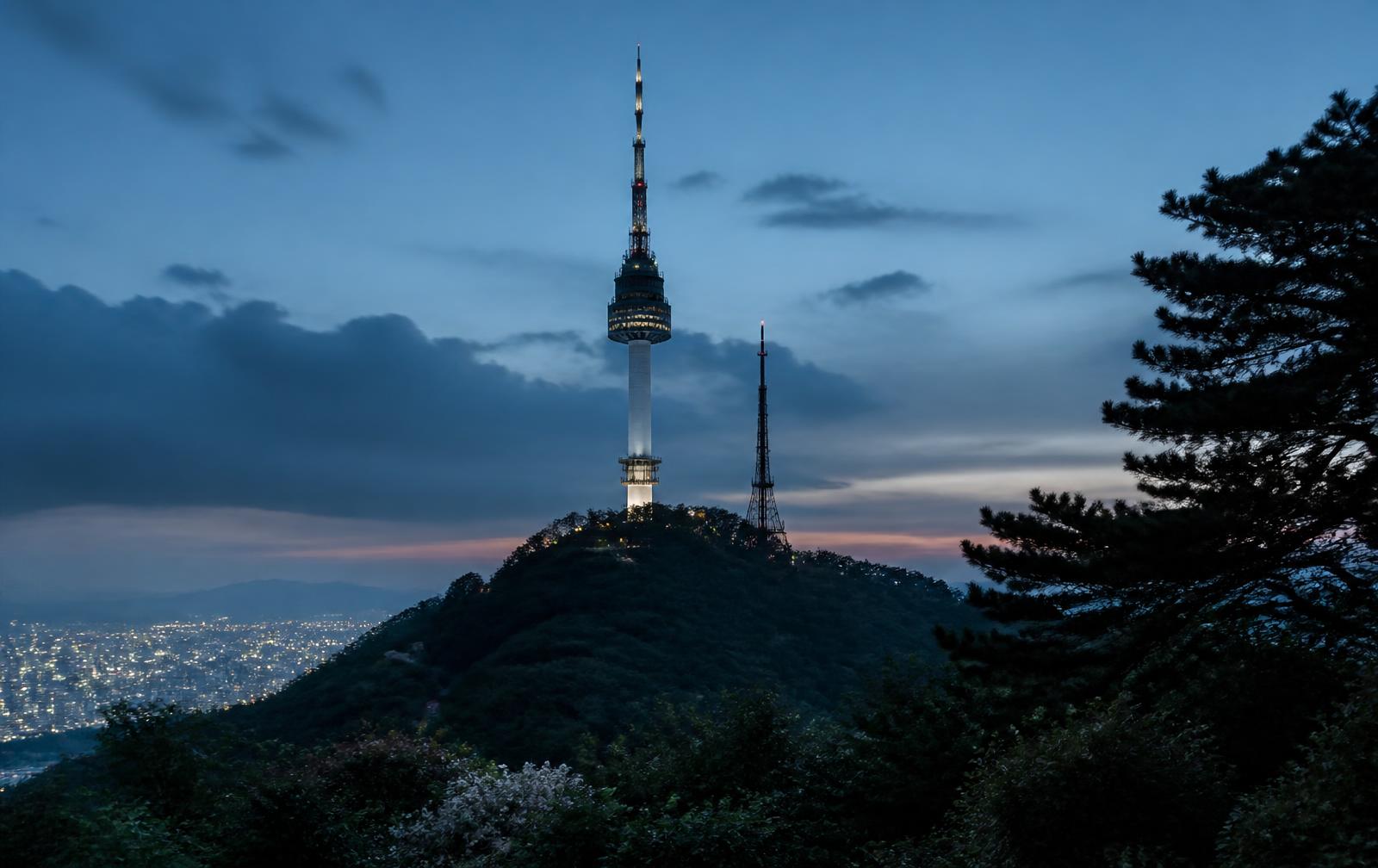 N Seoul Tower illuminating Namsan above the Seoul cityscape at night