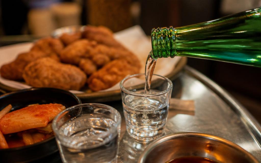 Soju being poured into small glasses