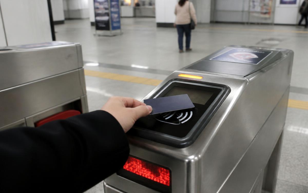 Tapping a transit card at a Seoul subway fare gate