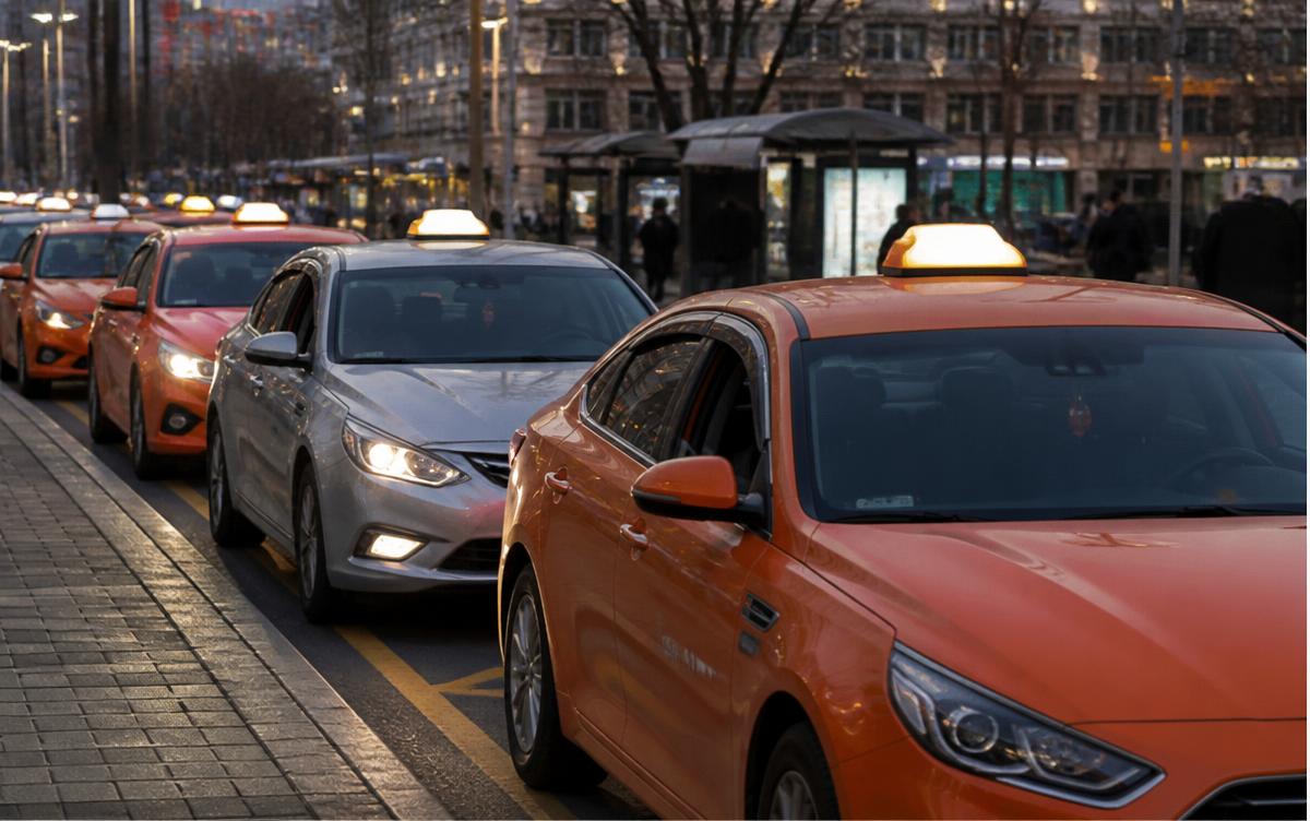 Orange and silver Korean taxis queued at a Seoul taxi stand